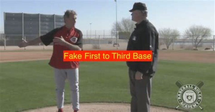 Can a pitcher fake to third and throw to first?