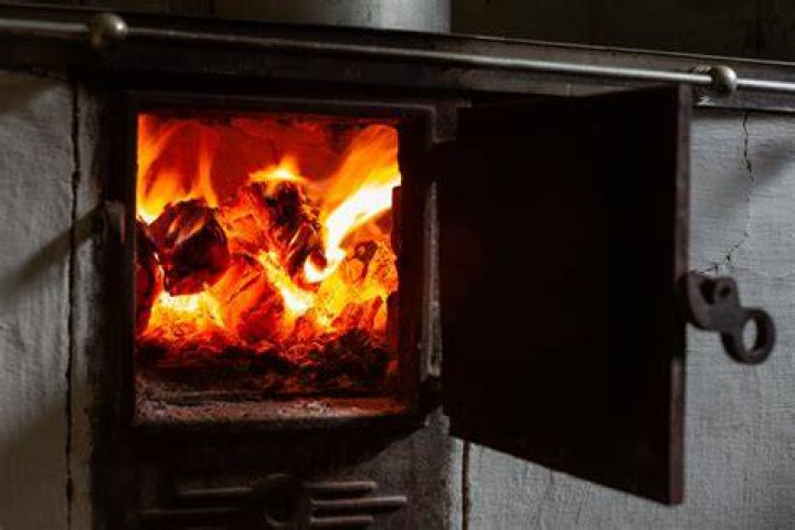 How do I get more heat from my fireplace?