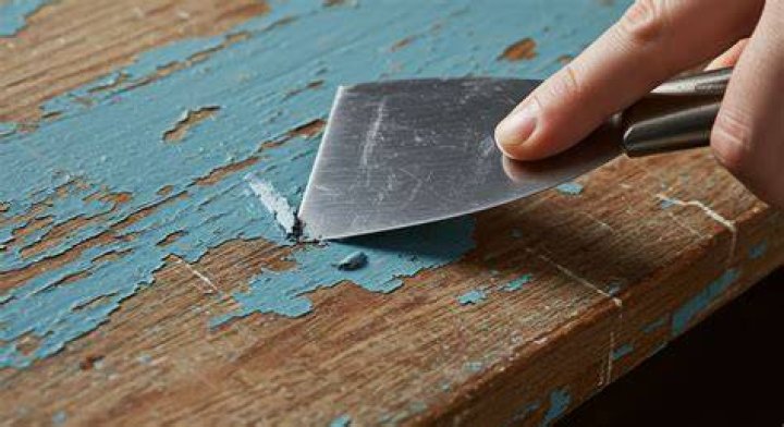 How do I remove old paint from wood furniture?