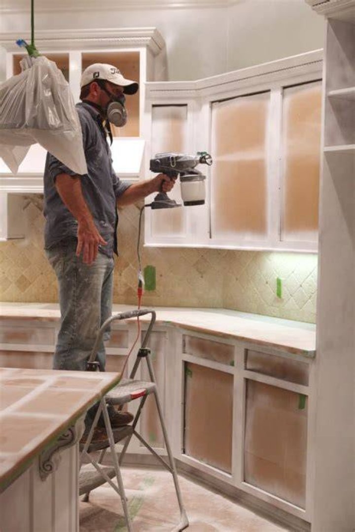 How do professionals paint kitchen cabinets?