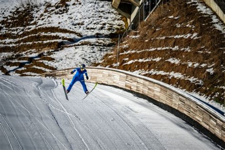 How do ski jumpers get to the top of the hill?