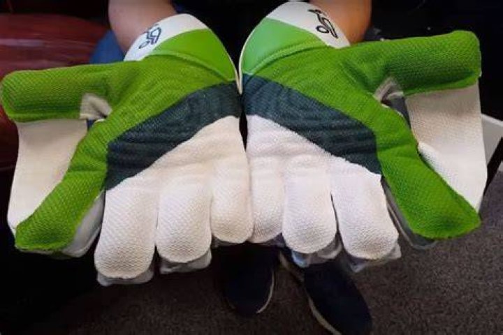 How do wicket-keepers protect their fingers?