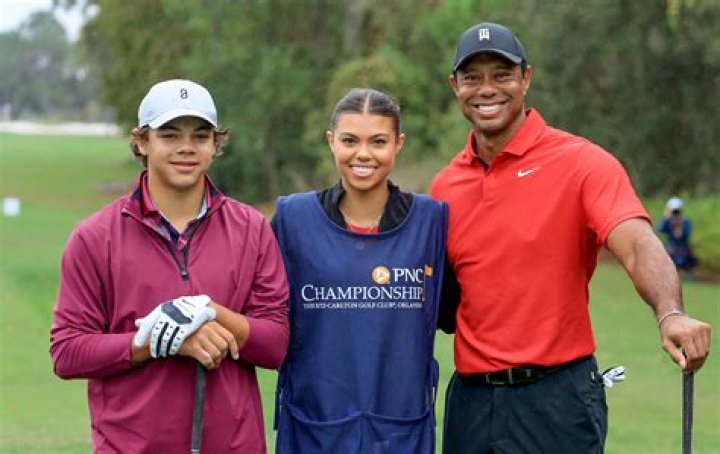 How does Tiger Woods hold his club?