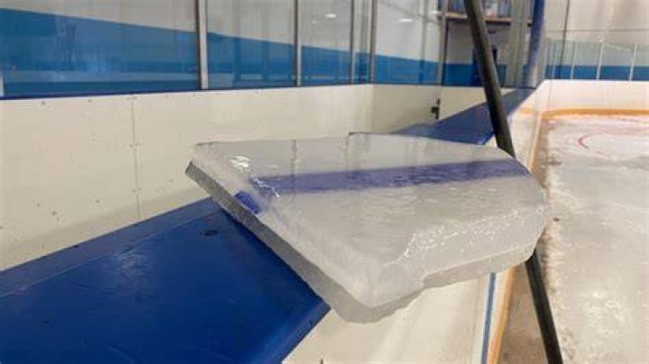 How thick is the ice on an ice hockey rink?