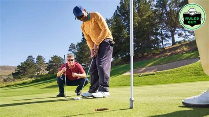 Is it illegal to stand behind someone while they are putting?