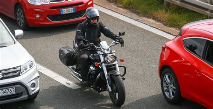 Is it legal to drive between cars with a motorcycle?