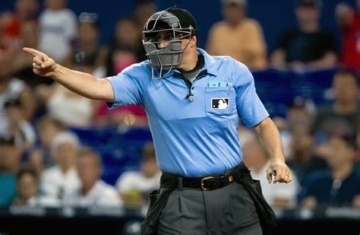 What does the umpire do in a football game?
