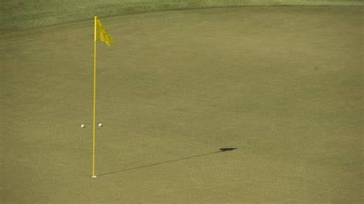 What happens if the ball hits the flag in golf?
