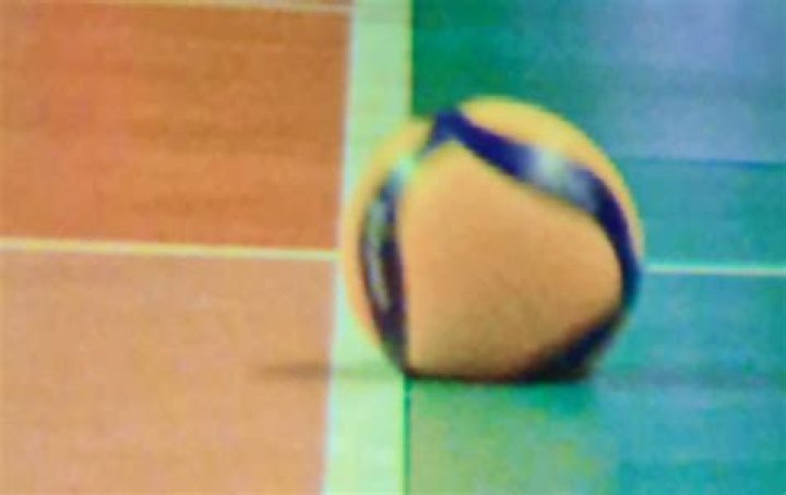 What happens if the ball hits the line in volleyball?
