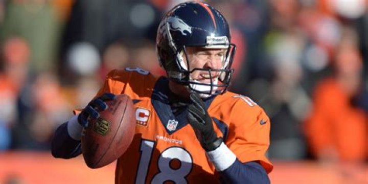 What is Peyton Manning's record against Tom Brady?