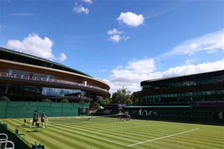 What surface is Wimbledon played on?
