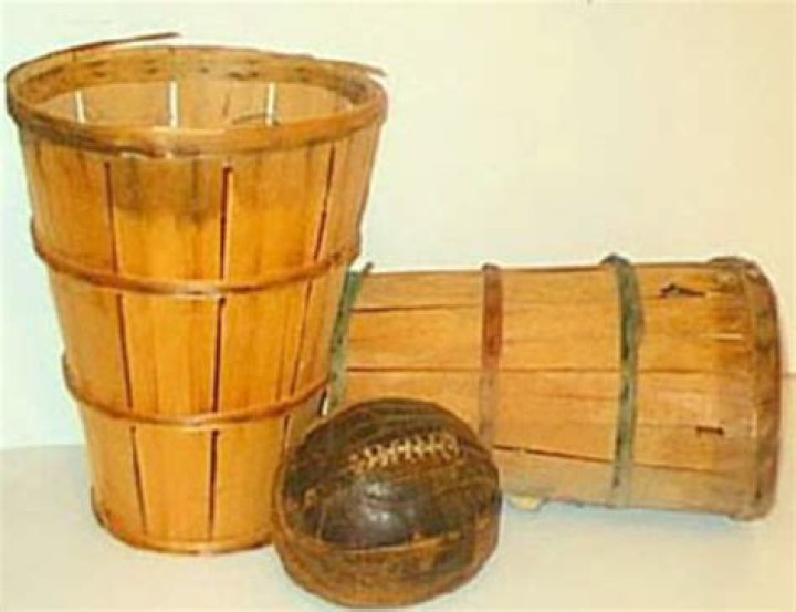 What was the first basketball hoop made of?