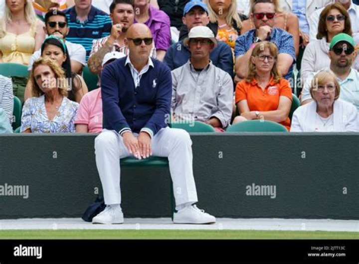 Where do tennis line judges stand?