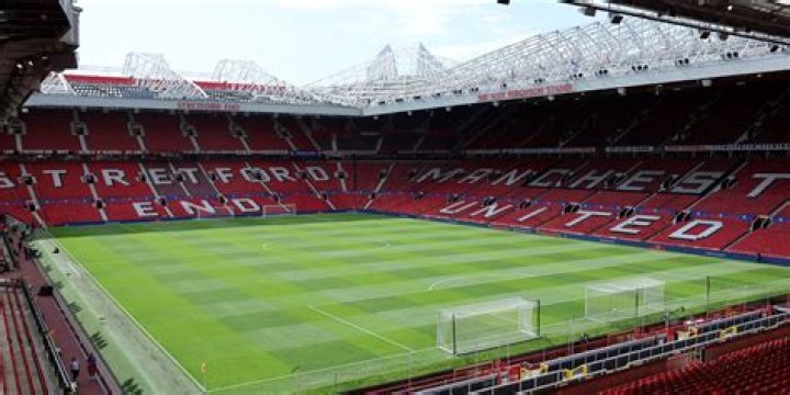 Where do the players enter Old Trafford?