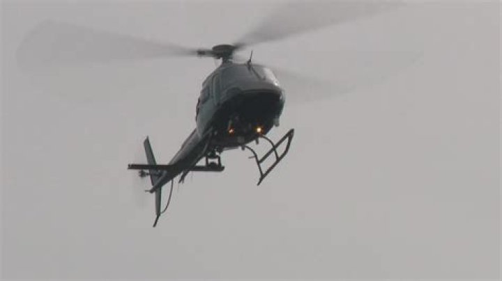 Why do helicopters circle around neighborhoods at night?