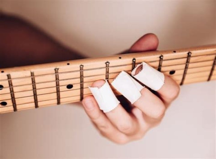 Why do middle blockers tape their fingers?