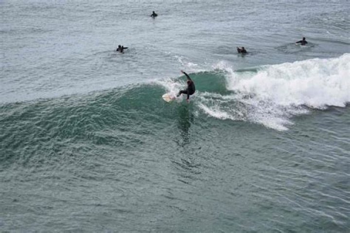 Why do surfers drag their hand in the wave?