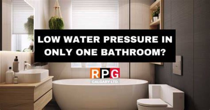 Why is water pressure low in one bathroom?